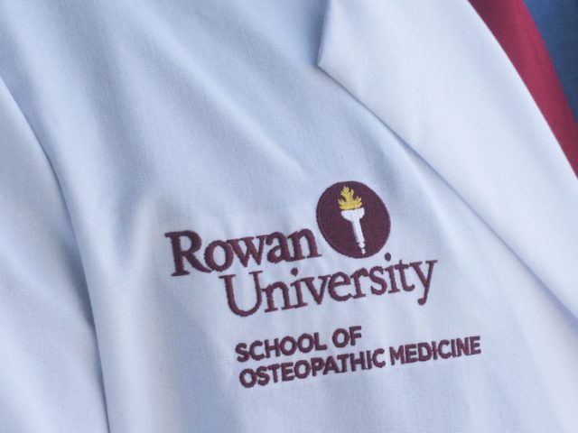 Lab coat of Nathan Carroll labeled "Rowan University: School of Osteopathic Medicine"