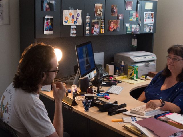 Professor Quigley and a student sit in her office during a meeting