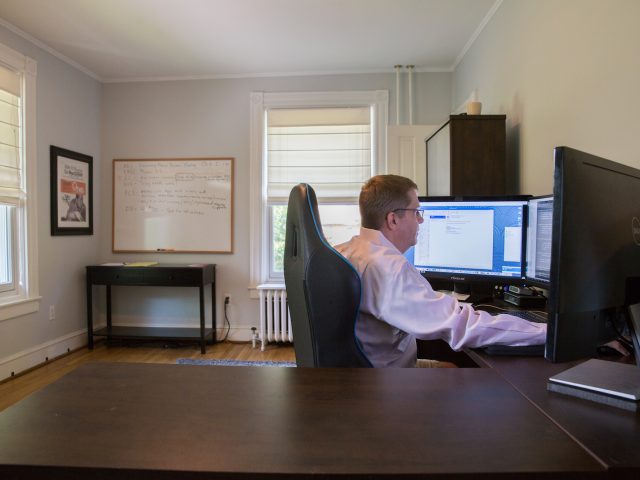 Steve McKeon working on his desktop computer in his home office