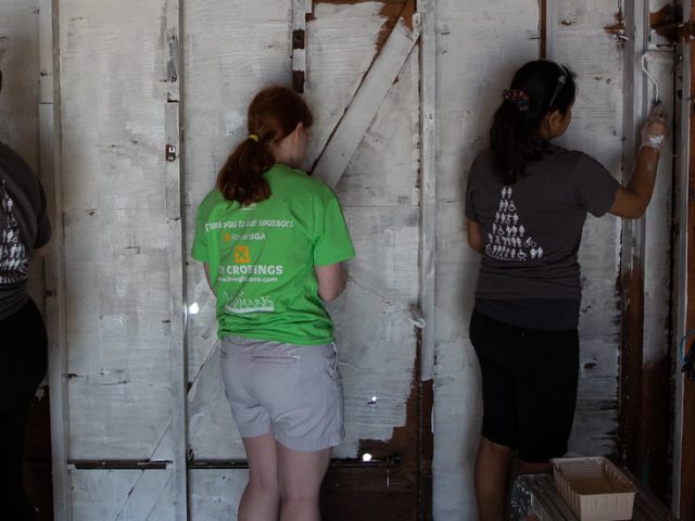 First-Year Volunteer Connection student leader Rose Dickmann (center, in green) helps out at the St. Bernard's disaster relief project.