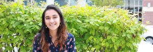 Molecular and cellular biology major Amaal Khan sits outside on a bench