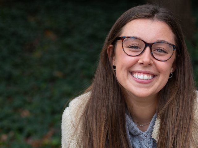 Biology major Roxy Urso sitting on a campus bench