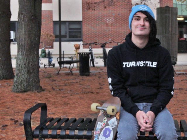 Freshman Music Industry major Devin Saienni sits on a bench on campus