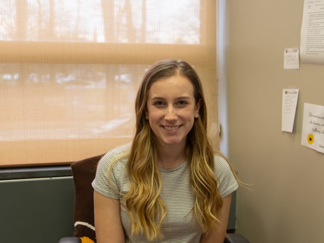 Cam sits in her office in the Student Center.