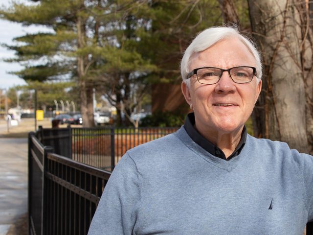 Kipp Matalucci, German adjunct instructor at Rowan, stands outside on campus.