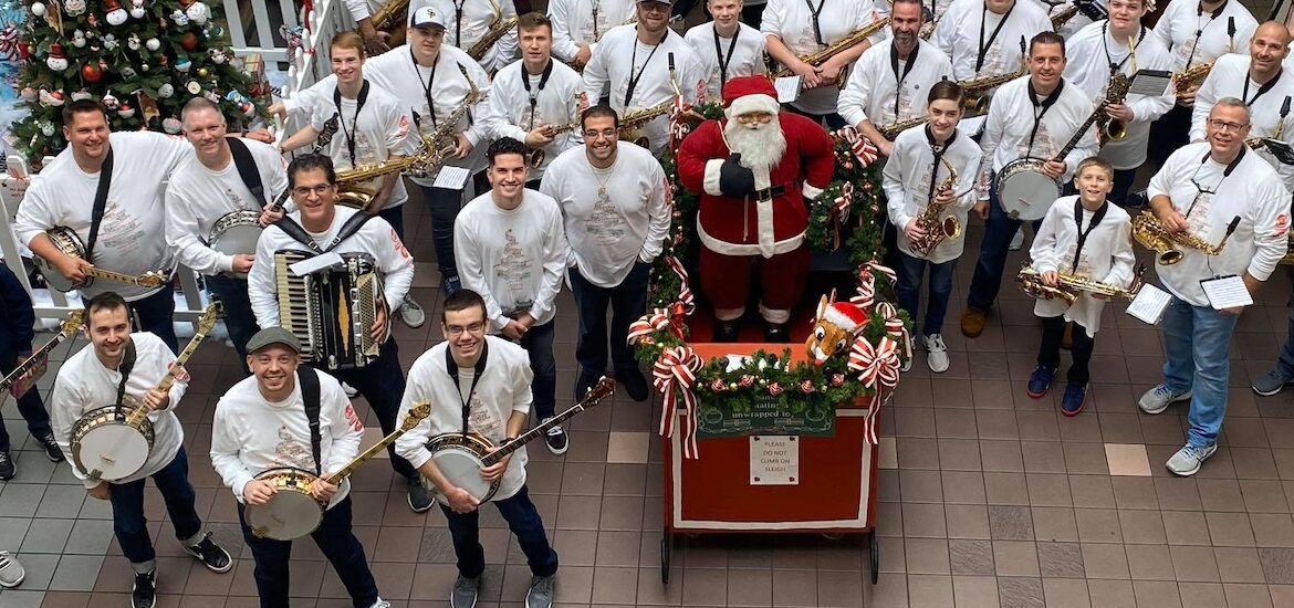 A view of TJ's Mummers group from above, posing with instrument and Santa and his sleigh.