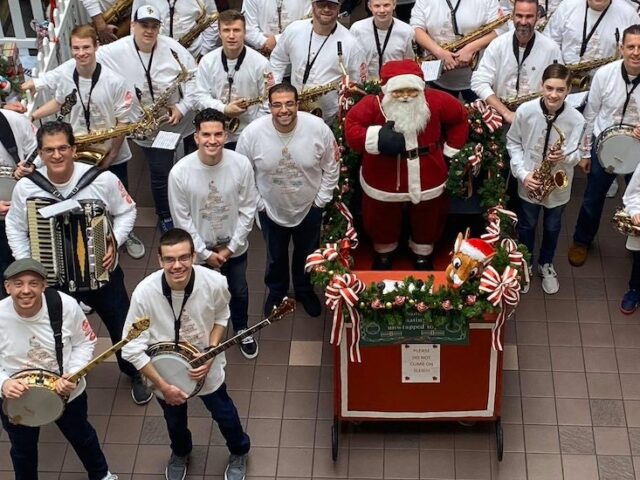 A view of TJ's Mummers group from above, posing with instrument and Santa and his sleigh.