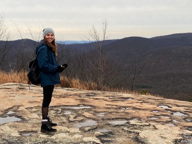 Alyssa Bauer poses at the top of Bear Mountain, NY.