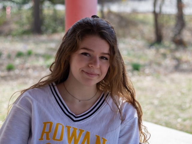 Rowan University junior Abby Broschard sitting outside.