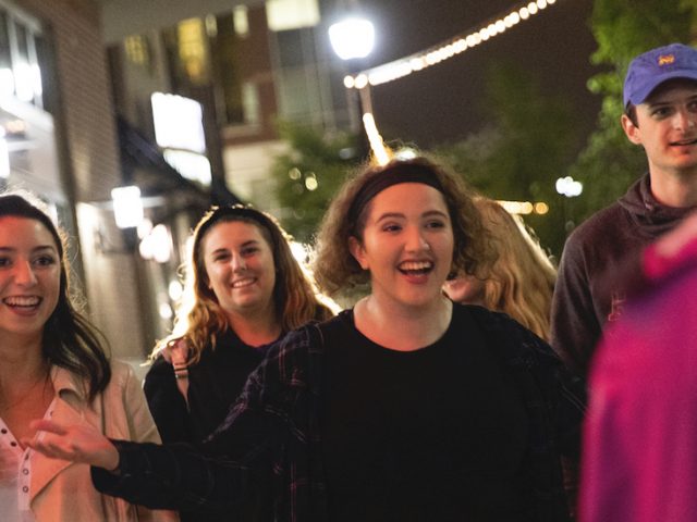 Bianca and friends happily greet a friend on Rowan Boulevard.