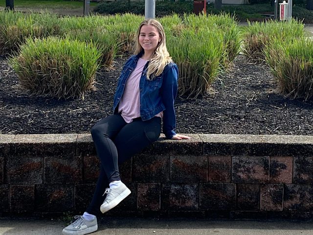 a photo of julia sitting outside the Rec Center