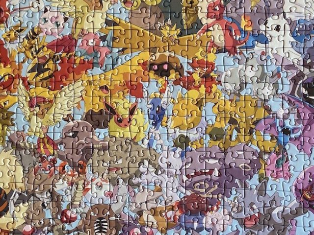 Close up of a completed multi-colored Pokemon puzzle.