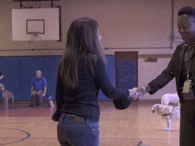 Rosetta shaking hands with another dog trainer.