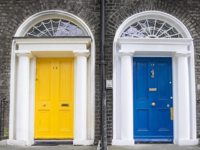 Stock image of a yellow door and a blue door side by side.