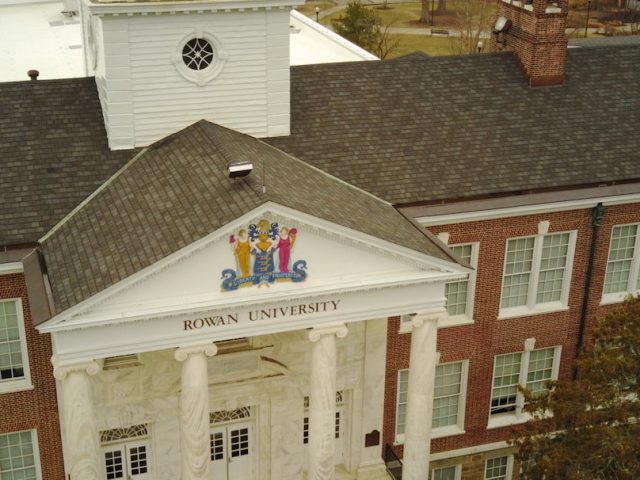 Drone view of brick and white columns of Bunce Hall.