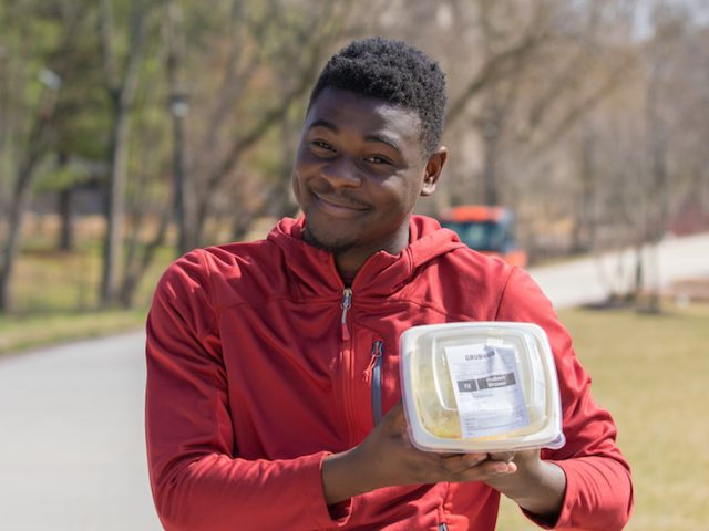 Robert Brown poses with Freshens rice bowl on campus.