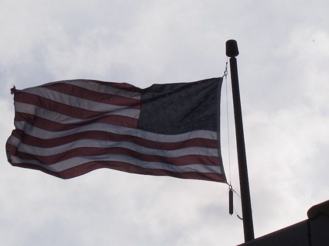 An American flag flying in the wind.