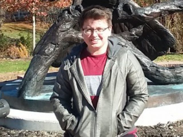 Emerson in front of the Prof statue visiting Rowan.