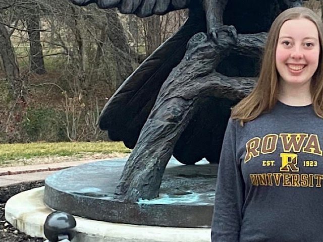 Selfie of Paige in front of the Prof statue.