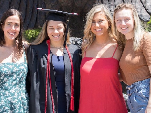 casey and three friends posing for a grad pic.