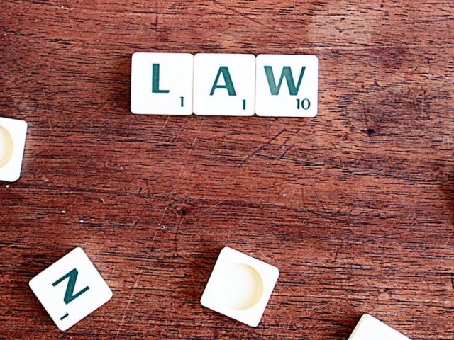 Stock image of Scrabble tiles spelling law.