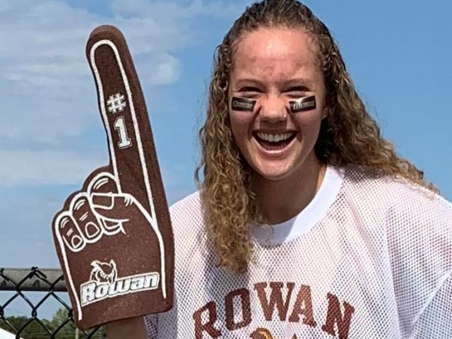 Bella wearing Rowan gear with a foam Rowan finger.