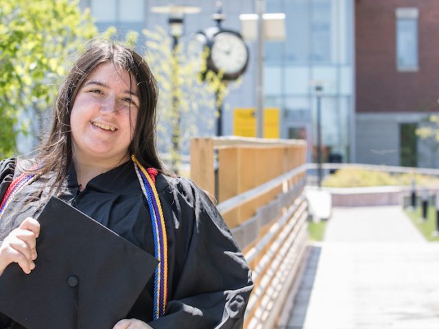 Stephanie poses in front of business hall.