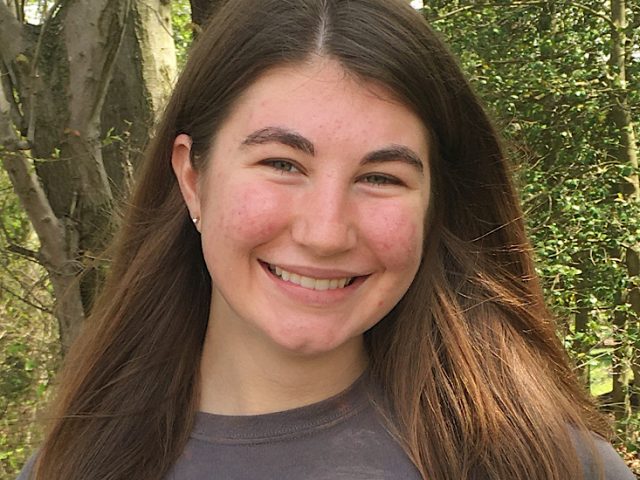 Photo of Megan outside in a wooded area