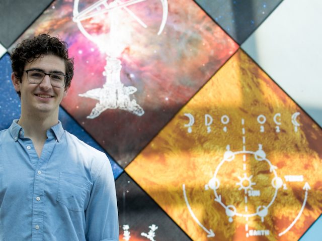 Aaron standing outside science hall