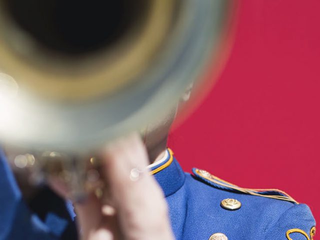 stock image of a trumpet player against a red background