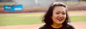 Caitlin poses at a stadium.
