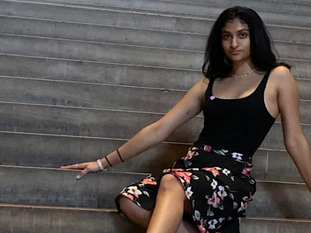 Photo of Padmini sitting on a large staircase