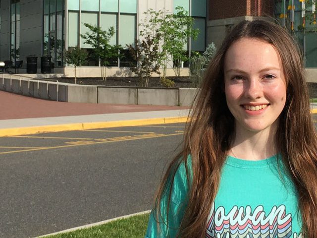 Lily stands in front of Business Hall.