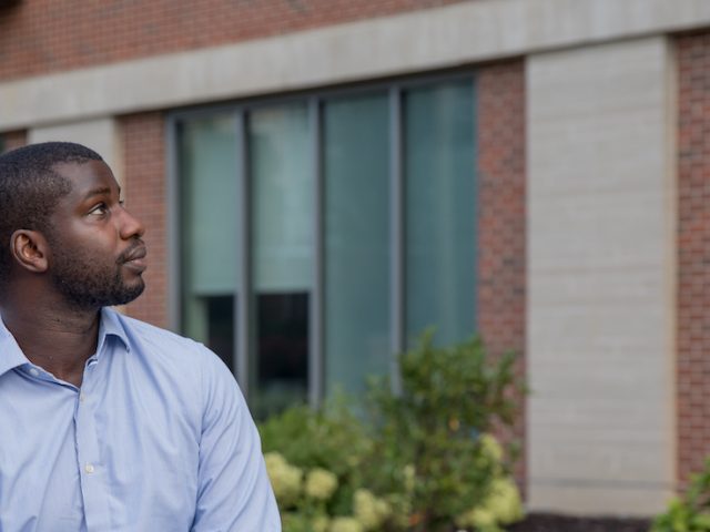 Jamal sitting outside the business building.