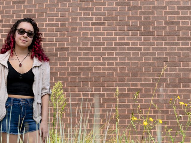 Stephanie at Wilson Hall with greenery and flowers