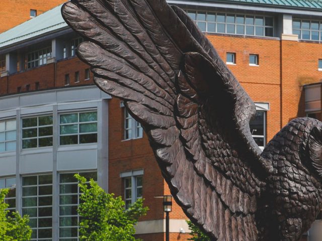 Exterior shot of the Owl statue and the back of Campbell Library.