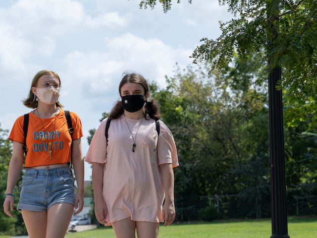 Sammy and Vicky walk together on campus.