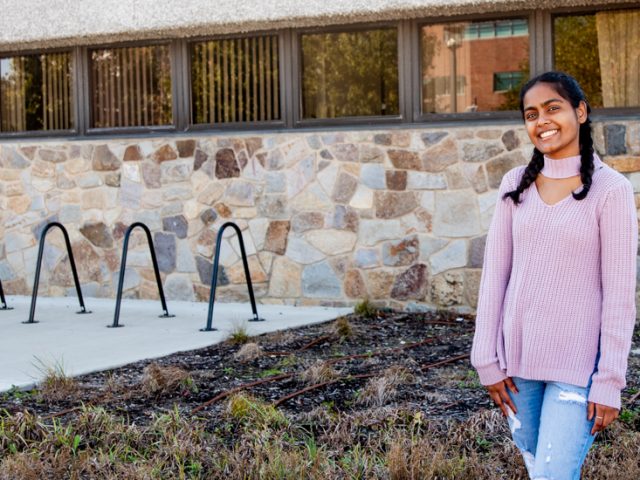 Alisa standing outside of Robinson Hall.