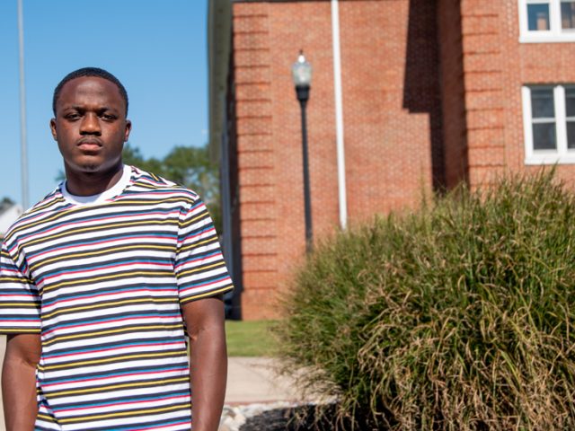 David stands outside on campus.