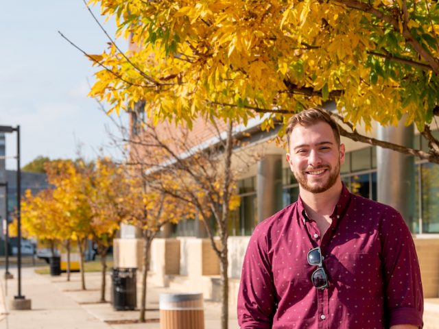 Elementary education student poses outside on campus.