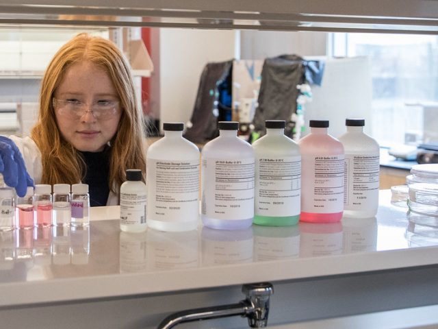 Chemical engineering student works in lab.