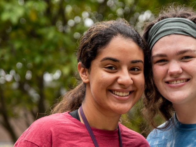 Roommates pose together outside on campus.