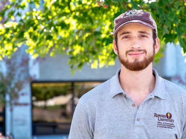 Will, the student leader of Fresh For All poses on Rowan's campus.