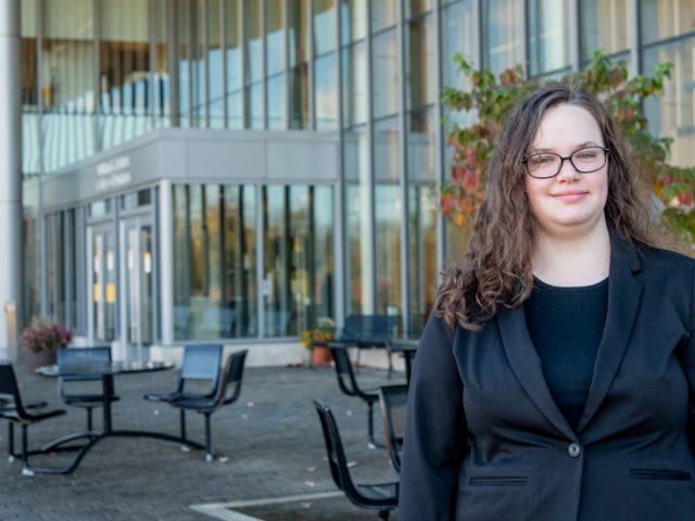 Allison stands outside of Business Hall.