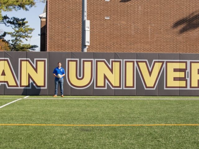 Chase poses on the intramural field at Rowan.