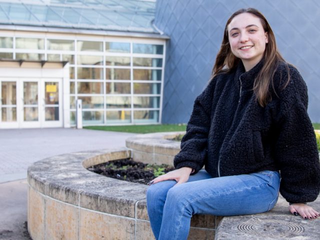 Erin sitting outside of the Science Hall.