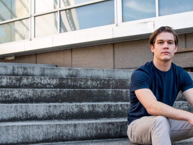 Liam sitting outside on the Engineering steps.