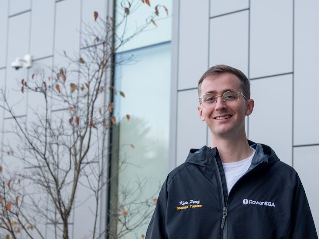 Kyle standing at Business building.