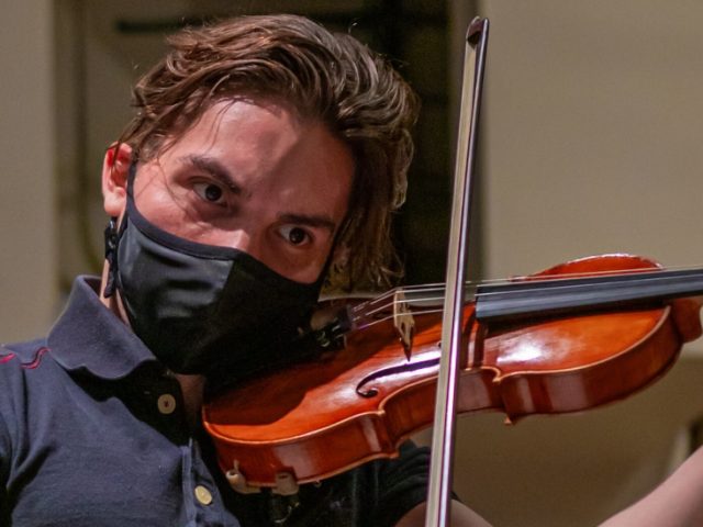 Juan plays the violin at Wilson Hall.