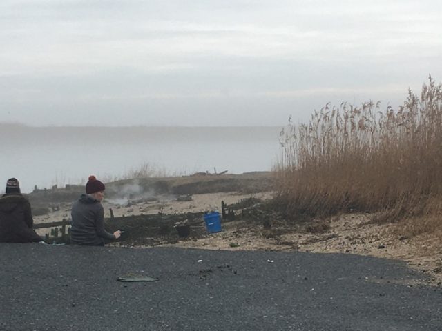 Madison sitting near a lake.